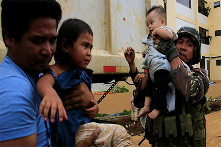 Government soldiers evacuate residents of a village near the embattled Marawi City, Philippines, on May 31, 2017