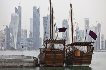 Ttraditional arab ships with the flag of Qatar