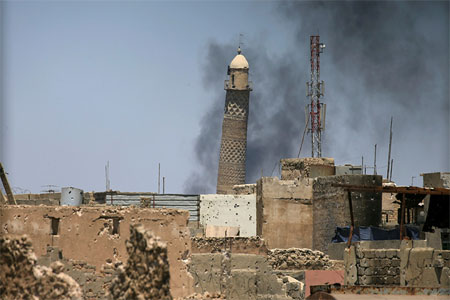 Al-Hadba minaret at the Grand Mosque is seen through a building window in the old city of Mosul, Iraq on June 1, 2017