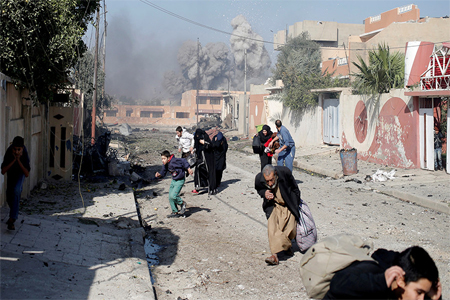 People run in panic after a coalition airstrike hit Islamic State fighters positions in Tahrir neighbourhood of Mosul, Iraq