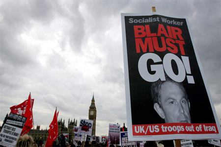 A poster is held up by one of thousands of anti-war campaigners taking to the streets of London, October 17, 2004