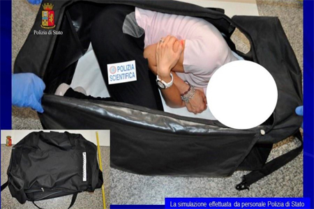 A person taking part in a reenactment by Italian police shows how a kidnapped British model was kept in a bag, in this handout picture provided by the Italian Police in Milan on August 5, 2017.