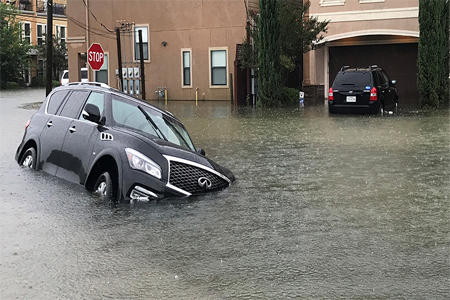 A vehicle sits half submerged in flood waters in a residential area in the aftermath of Hurricane Harvey in Houston, Texas, U.S., August 27, 2017.