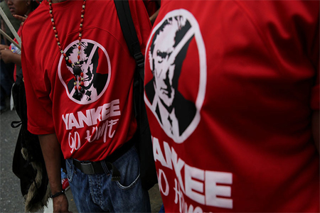 Civilians wear T-shirts with the face of US President Donald Trump as they parade during a military exercise in Caracas, Venezuela, August 26, 2017