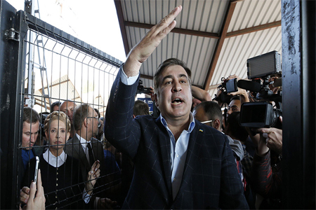 Former Georgian president Mikhail Saakashvili accompanied by Ukrainian opposition leader Yulia Tymoshenko speaks to media at a railway station in Przemysl, Poland September 10, 2017