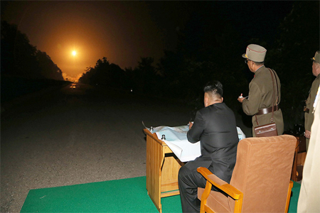 North Korean leader Kim Jong Un provides field guidance during a tactical rocket firing drill