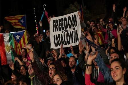 People react as they gather at Plaza Catalunya after voting ended for the banned independence referendum, in Barcelona, Spain October 1, 2017