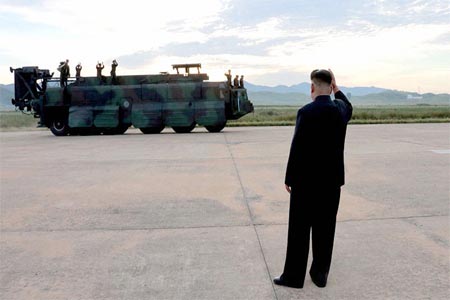 North Korean leader Kim Jong Un guides the launch of a Hwasong-12 missile.