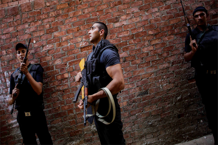 Egyptian security forces stand guard in Giza's Kerdasa district, south of Cairo, Egypt.