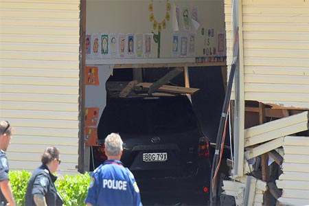 New South Wales emergency services personnel and police look at a vehicle that crashed into a primary school classroom in the Sydney suburb of Greenacre in Australia, November 7, 2017.