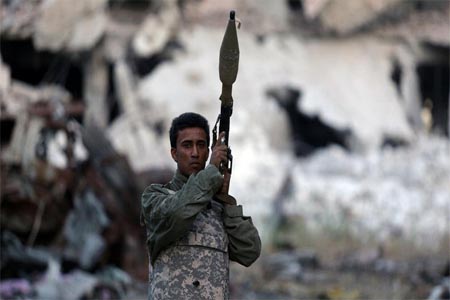A member of the Libyan National Army holds a weapon during clashes with extremist militants in Khreibish district in Benghazi.