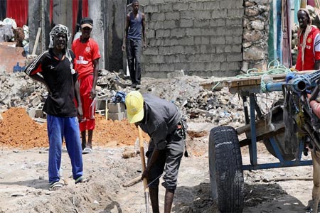 Construction workers repair buildings at the site of the October 14 twin bombings, in Mogadishu, Somalia, on October 25, 2017.