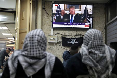 Palestinians watch a televised broadcast of Trump delivering an address where he is expected to announce that the United States recognises Jerusalem as the capital of Israel, in Jerusalem's Old City. (Reuters)