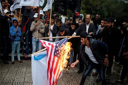 Palestinians burn an Israeli and a US flag during a protest against US intention to move its embassy to Jerusalem and recognize the city as Israel's capital, in Gaza City December 6, 2017