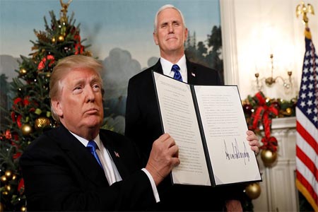 US President Donald Trump holds up the proclamation that the United States recognizes Jerusalem as the capital of Israel, December 6, 2017