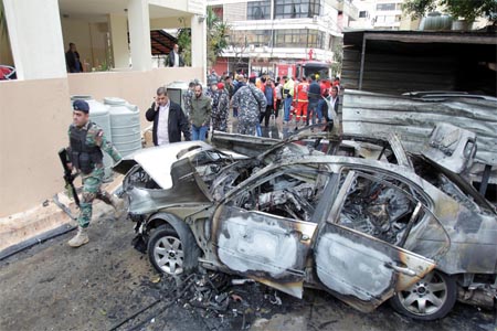 Lebanese soldiers are seen inspecting the damaged car in Lebanon's Sidon.