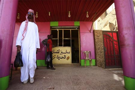 Angry Sudanese queued outside bakeries in Khartoum as bread prices doubled overnight.