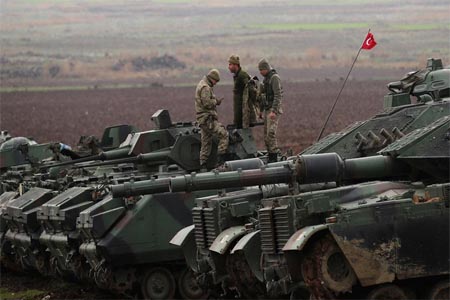 Turkish army tanks and armoured personnel carriers (APC) are seen near the Turkish-Syrian border in Hatay province.