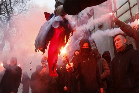 Ukrainian ultranationalists burn the Russian state flag, which they took from the office of the Russian Center of Science and Culture, in Kiev, Ukraine on February 17, 2018.