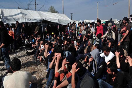 migrants and refugees blocking railway tracks to protest in the makeshift camp at the Greek-Macedonian border, near the Greek village of Idomeni where thousands of them are stranded.