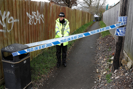 Police work in the alleyway near the home of former intelligence officer Sergei Skripal in Salisbury, Britain, March 28, 2018.
