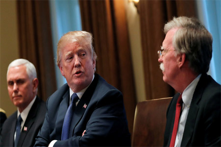US President Donald Trump receives a briefing from new National Security Adviser John Bolton (R) at the White House, April 9, 2018