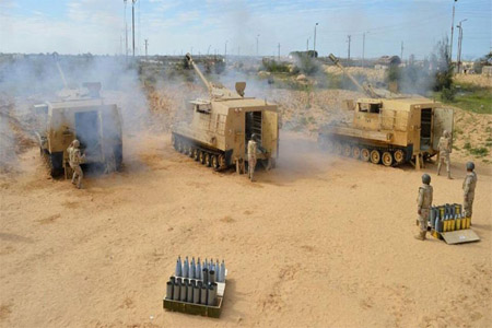 Egyptian Army soldiers fire artilleries during a launch of a major assault against militants in Sinai