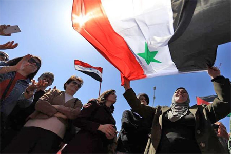 Participants protest against Western strikes on Syria in front of US embassy in Amman on Saturday