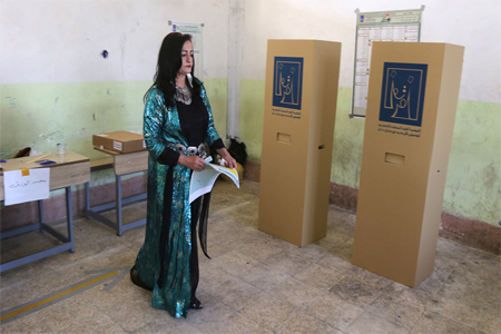 امرأة كردية تستعد للإدلاء بصوتها في مركز اقتراع بكركوك