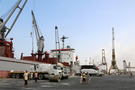 A crane unloads food aid provided by UNICEF at the port of Hodeida