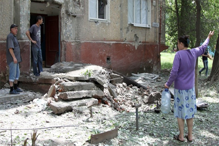 Residents in the courtyard of a residential building hit by shelling in the village of Gorlovka, Donetsk Region