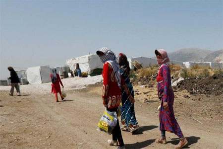 Syrian refugee women walk together at a camp for Syrian refugees near the town of Qab Elias, in Lebanon's Bekaa Valley, August 8, 2017. REUTERS/Jamal Saidi