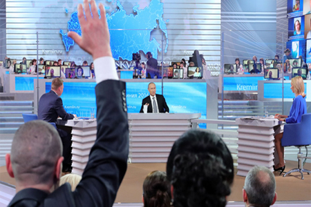 President Vladimir Putin answering questions coming from Russian citizens in the annual Q&A live nationwide broadcast from the Moscow Gostiny Dvor studio, April 14, 2016. © Michael Klimentyev / Sputnik