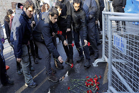 Men lay flowers outisde the Reina nightclub by the Bosphorus, which was attacked by a gunman, in Istanbul, Turkey, January 1, 2017