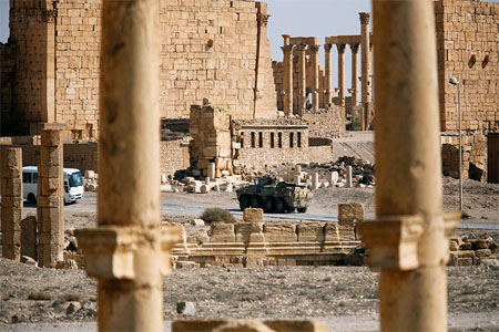 A military vehicle drives near ruins in the historic city of Palmyra, Syria March 4, 2017.