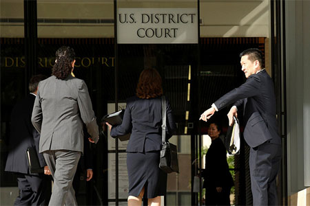 Hawaii Attorney General Douglas Chin (R) arrives at the U.S. District Court Ninth Circuit in Honolulu, Hawaii, March 15, 2017