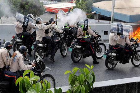 Riot police fire tear gas toward opposition supporters in Caracas, Venezuela April 24, 2017.