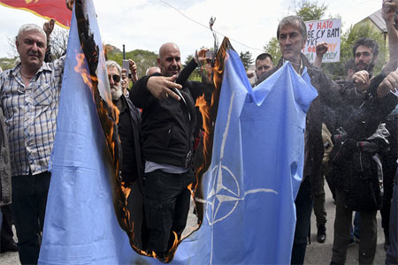 Protesters burn the NATO flag on April 28, 2017 during a protest against the Montenegro's accession to NATO in Cetinje.